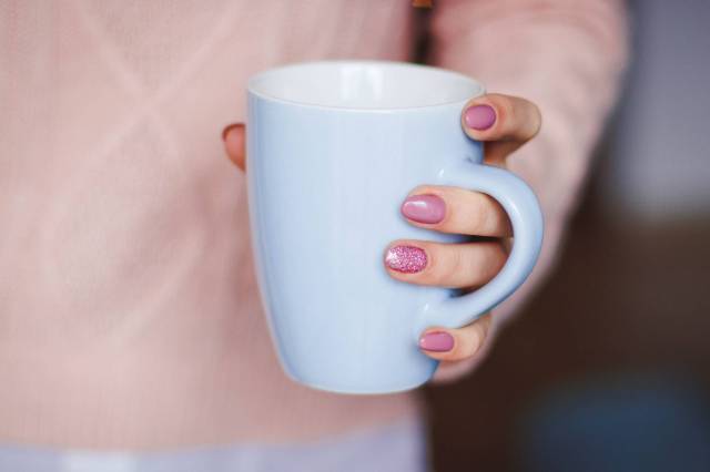 person holding white ceramic mug