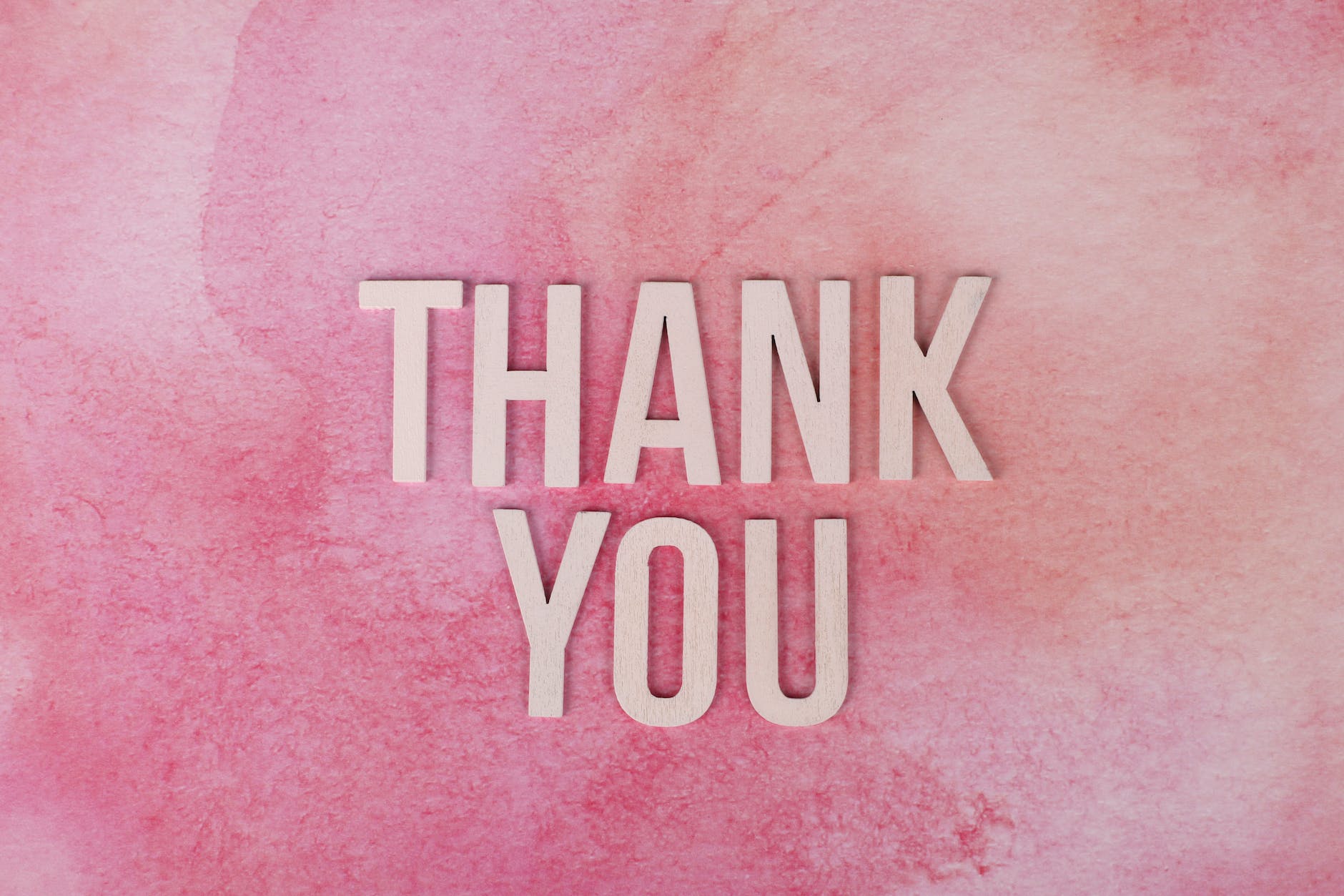 thank you text on pink surface